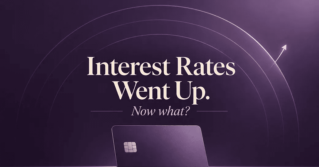 Purple gradient background with concentric circles, upward arrow, and a credit card with text reading 'Interest Rates Went Up. Now what?'